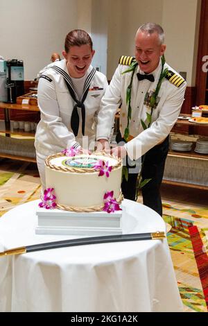 221021-N-ML137-1106 KOLOA, Hawai`i (Oct. 21, 2022) — Capt. Brett Stevenson, commanding officer of Pacific Missile Range Facility (PMRF), Barking Sands, right, and Mass Communication Specialist 2nd Class Bodie Estep cut a cake during a U.S. Navy Ball at the Grand Hyatt Kaua`i Resort and Spa in celebration of the Navy’s 247th birthday. Continuing with tradition, the youngest member and oldest attendant of the ball have the honor of cutting the cake together. The theme of the U.S. Navy’s 247th birthday was “On Watch - 24/7 for 247 Years,” which highlights our Navy’s enduring ability to remain ful Stock Photo